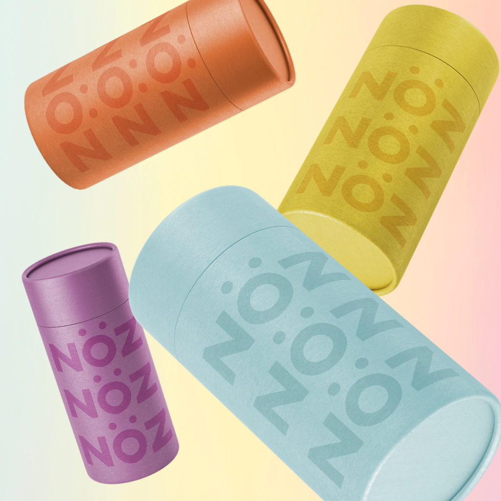 Variation of 4 different colors of sunscreen sticks by NOZ : orange, yellow, blue, and purple.